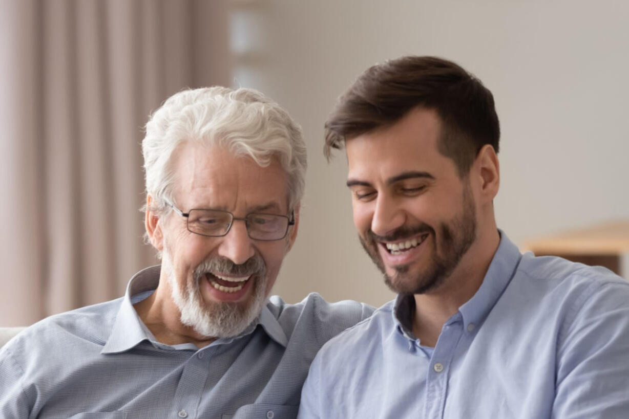 Older man and younger man laughing Older man and younger man laughing