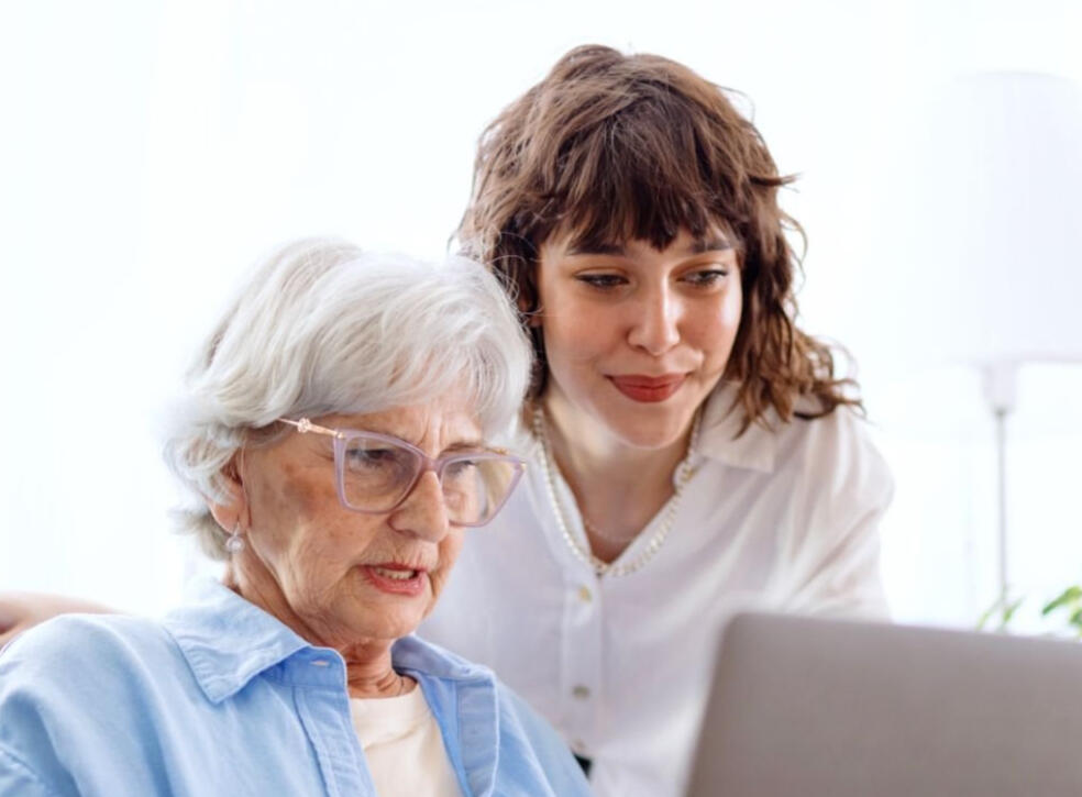Older woman and younger woman looking at computer